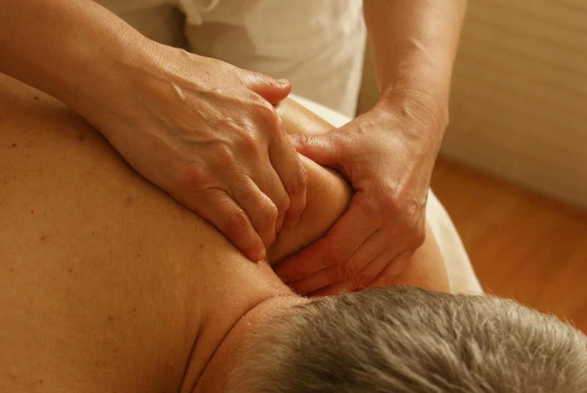 Attentive hands working with a client's shoulder